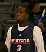 A basketball player wearing a black jersey with the word «PISTONS» and the number 3 on the frontRodney